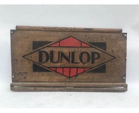 An embossed Dunlop tin advertising sign, 24 x 13 1/2". 