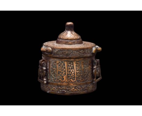 Ca. Mid to late 12th century AD. A flat-bottomed copper inkwell comprising a separate lid and a slightly flaring, cylindrical