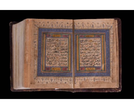 Dated 1021 Hijrah / 1612 or 1613 AD. An illuminated Quran decorated with gold leaf turquoise blue and red pigments. In Naskh 