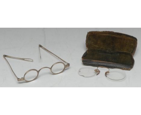 A pair of George III silver spectacles, oval lenses and arched bridge, folding temples culminating in pierced loops, 11.4cm w