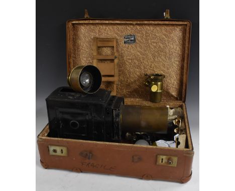 A late Victorian black lacquered and brass magic lantern, canted pine plinth, 43.5cm long, c. 1880; a collection of contempor