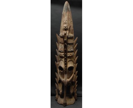 Tribal Art - a large Papua New Guinea floor standing sculpture, the stylised mwei mask terminating in a bird, figure to foreh