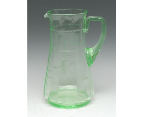 An early 20th century uranium glass water jug, lightly fluted and engraved with leafy stems and Art Deco lines, ground pontil