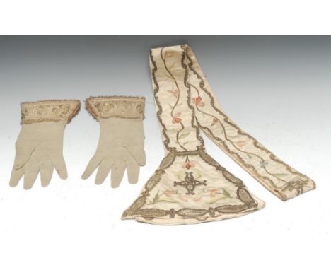 A pair of 17th century leather suede gloves, the deep tab cuffs embroidered with a geometric maze in silver-coloured threads,