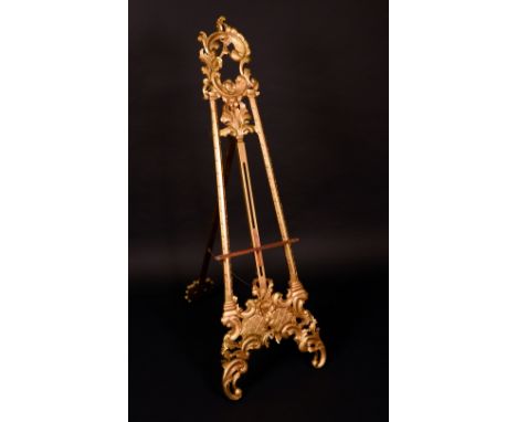 A Rococo gilt softwood picture easel, acanthus-capped leafy C-scroll cresting, laureate stratchers, shaped scrolling apron wi