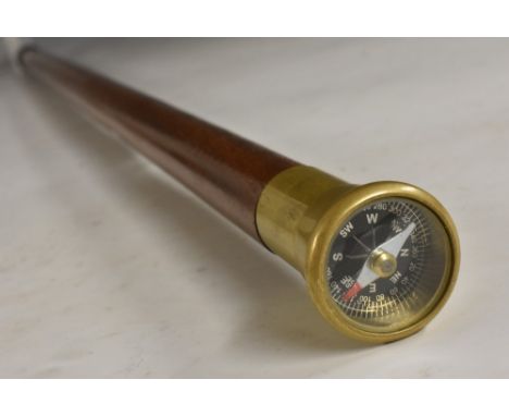A gentleman's novelty walking cane, the brass pommel with a compass, hardwood shaft, 84.5cm long 