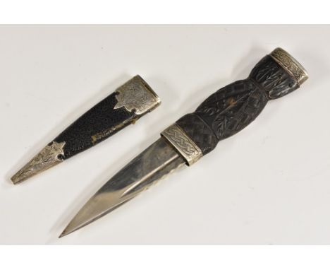 A George V silver-mounted Scottish ceremonial sgian-dubh knife, 7.8cm single-edged blade, leather scabbard, checkered horn gr