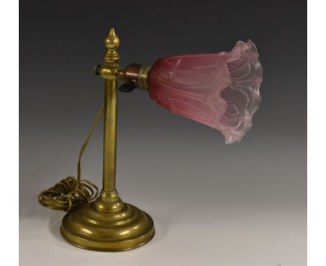 An early 20th century brass adjustable desk lamp, moulded glass shade, momed circular base, 31.5cm high