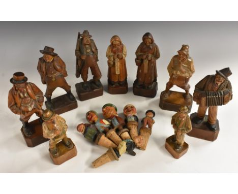 A collection of Black Forest figures, carved as musicians and characters from the street, the largest 19cm high, early 20th c