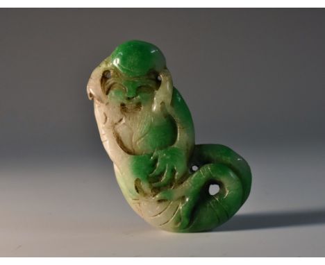 A Chinese two-tone jade amulet, of a Shou-Lao as a merman, the stone in tones of emerald and celadon green, 6cm long 