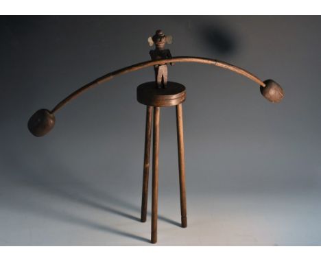 Folk Art - an early 20th century scratch-built equilibrium balance toy, as a figure balanced on a tall three-legged stool, 37