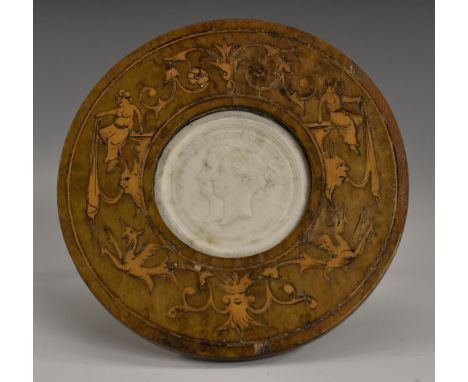 An Italian marquetry easel frame, enclosing a plaster cameo impression, after a 19th century medallion, depicting Queen Victo