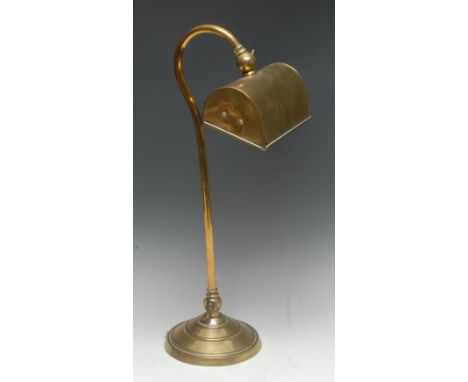 An early 20th century brass library desk lamp, the swan neck column with two adjustments, wide rectangular shade, circular ba