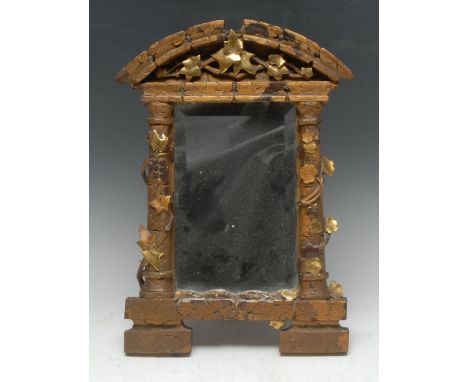 An early 20th century gilt gesso and softwood architectural looking-glass, arched cresting, the rectangular bevelled mirror p