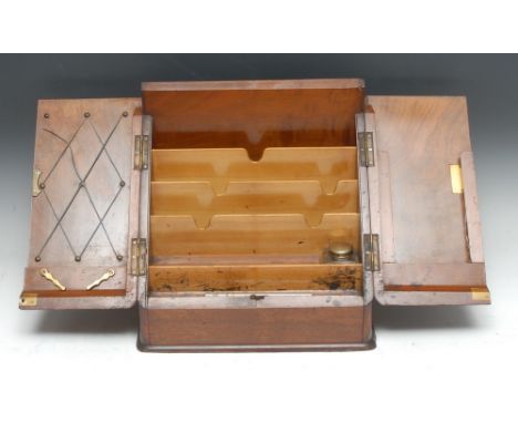 A Victorian walnut slope front stationery box, hinged twin-covers enclosing stepped divisions, an inkwell and pen compartment