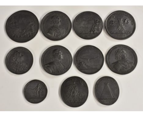A collection of 19th century alloy portrait medallions, after Russian Baroque originals, depicting Peter the Great and his mi