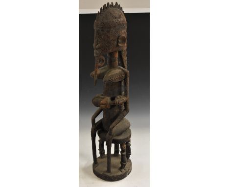 Tribal Art - an Afriican fertility figure, possibly Bamana, carved as a female figure feeding her infant child, seated, her s