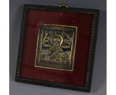 An Eastern Orthodox gilt brass icon, probably Russian, in relief with St Peter, traces of enamel, 6cm x 5cm, framed 