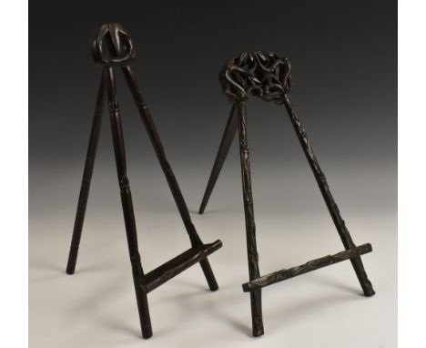 A Chinese hardwood table top easel, pierced and carved with leafy bamboo, 45cm high, c.1900; another, similar (2)