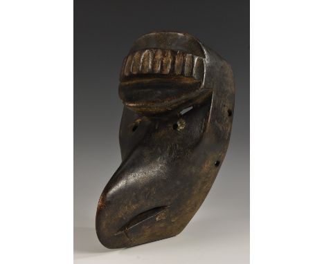 Tribal Art - an African ceremonial mask, probably Chokwe, carved with stylised avian features, fluted protuberance to forehea