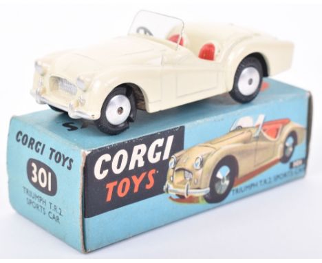 Corgi boxed 301 Triumph T.R.2 Sports car, cream with red seats and flat spun hubs, in blue picture box, generally excellent c