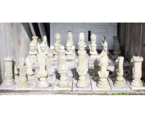 A lawn chess set, each square 29 x 29cm, height of king 61cm.