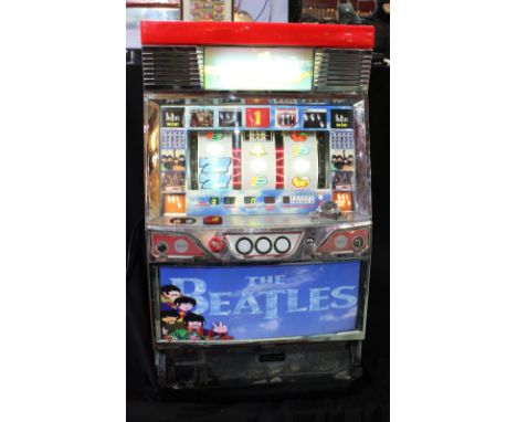 THE BEATLES; a modern table-top fruit machine with later applied printed Beatles imagery, height approx 80cm.Additional Infor