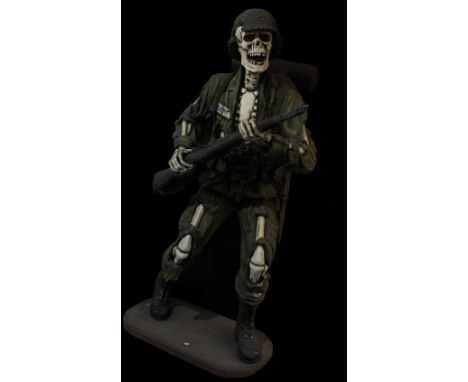 A large skeleton figure wearing Army-type uniform with gun prop/accessory, height 180cm.&nbsp;