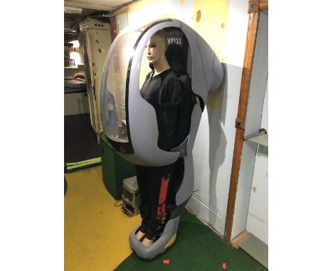 A futuristic-style pod believed to have been used in a Lynx deodorant advert housing mannequin, height approx 190cm.