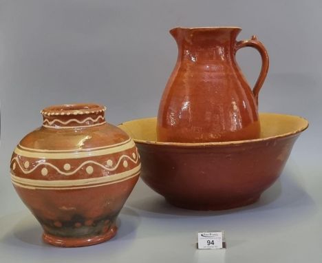 A Welsh Claypits Ewenny pottery baluster shaped vase with slip glazed banded decoration, having incised marks to base. 24cm h