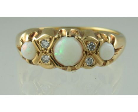 A three stone opal and diamond ring set in 18ct gold.  Ring size P & 1/2. Approx weight 4.7 grams.(B.P. 21% + VAT) 