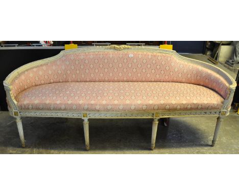 French design curved back canape upholstered sofa, the frame painted and gilded with central foliate cresting, stuff over sea