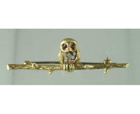 18ct gold Owl brooch.  Modelled as a diamond set owl with ruby eyes sitting on a textured branch.  Approx 55x17mm.  Approx we