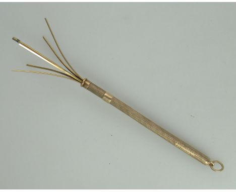 A 9ct gold cocktail stirrer.  With engine turned decoration and the initials, EJ.  Approx weight 6.9 grams. (B.P. 21% + VAT) 