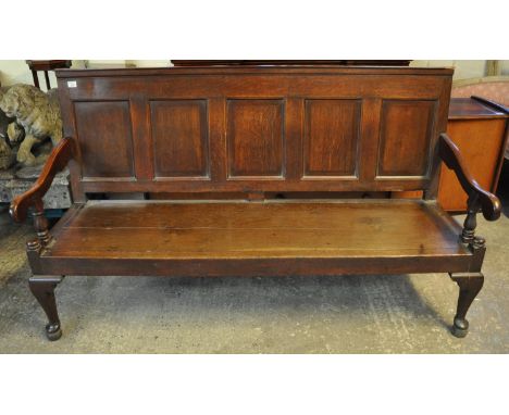 18th Century English oak panel backed settle, the moulded top above five mahogany cross banded panels, scroll shaped open arm