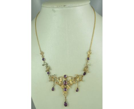 A late Victorian amethyst and seed pearl necklace set in 9ct gold.  With safety chain.  Length 16 inches (41cm).  Approx weig