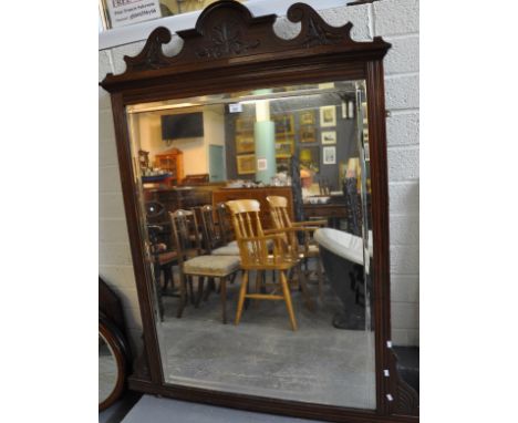 Edwardian mahogany framed over mantel mirror with foliate carved arch pediment and bevelled plate. 1M wide approx.(B.P. 21% +