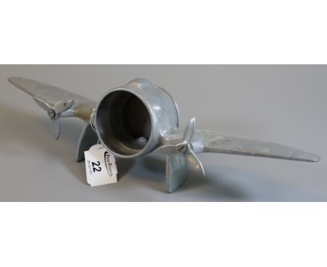 Unusual aluminium table clock case in the form of a twin engined aircraft. Lacks clock.(B.P. 21% + VAT) 