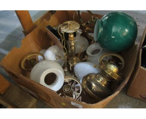 Box containing a pendulous brass light fitting with white glass shades and an ornamental oil burner with a green glass shade.