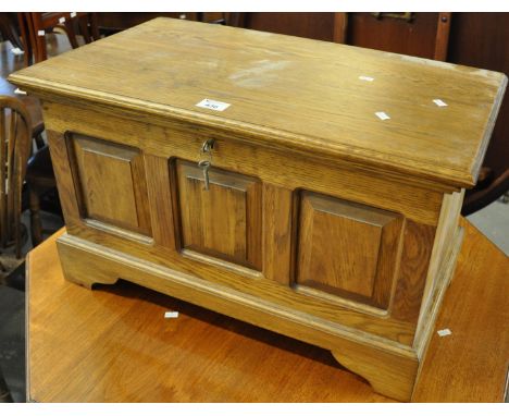 Reproduction Welsh oak Coffer Bach with bar hinged loose top above three raised and fielded panels on bracket feet. 65cm wide