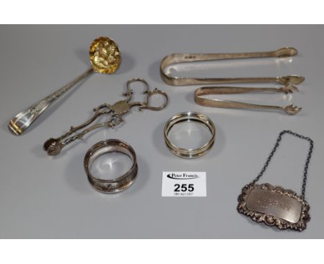Bag of assorted mixed Victorian and other silver items to include; napkin rings, tongs, sherry decanter label etc. 3.3 troy o
