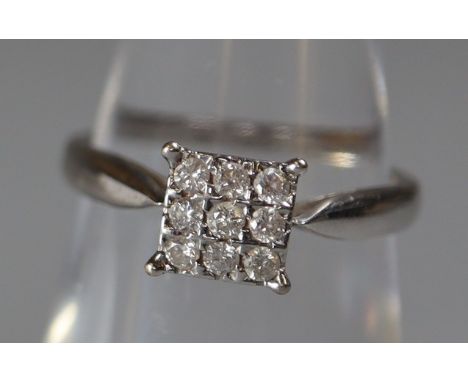 9ct white gold square diamond cluster ring.  Ring size K. Total diamond weight 0.20cts.  Weight approx 1.8 grams.(B.P. 21% + 