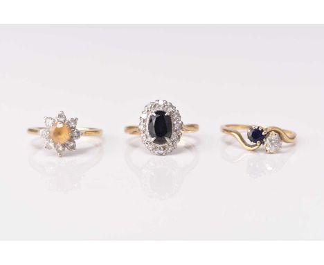 A two stone diamond and sapphire crossover ring, indistinctly stamped, size L, together with a sapphire and diamond oval clus