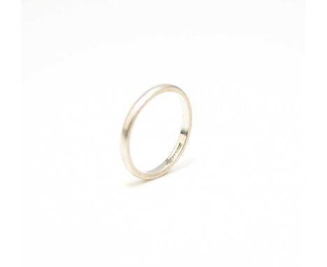 A white metal plain polished wedding band, stamped 'Platinum', ring size O 1/2, weight approx 3.6g