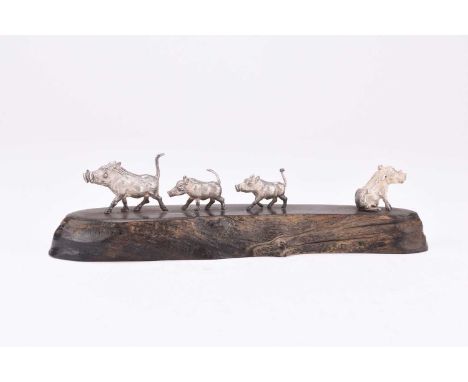 A Patrick Mavros silver model group of a family of Warthogs, presented upon wood base, 4.3cm high, 16cm long