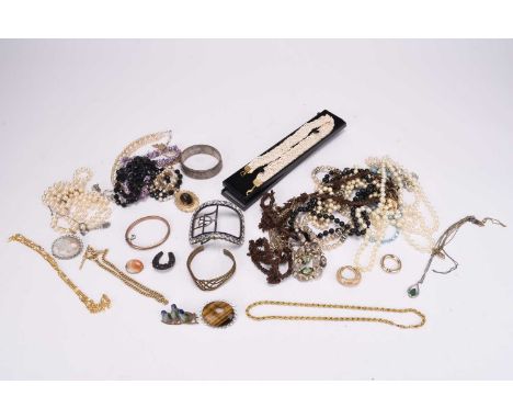 A large collection of costume jewellery, to include; a hardstone set brooch within yellow metal mount, a silver ingot pendant