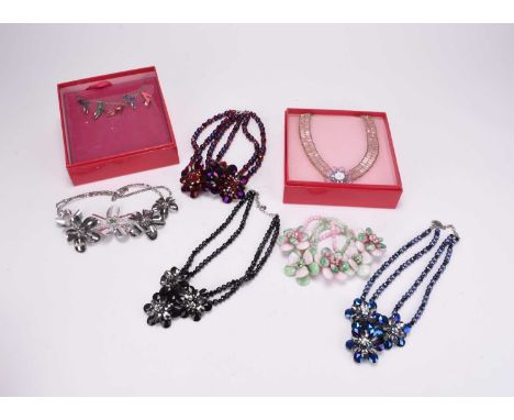 A collection of Butler and Wilson jewellery, comprising; seven floral necklaces, a Disney Princess enamel shoe necklace and a