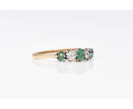 A five stone diamond and emerald ring, the three rectangular cut emeralds interspersed with two old mine cut diamonds, claw s