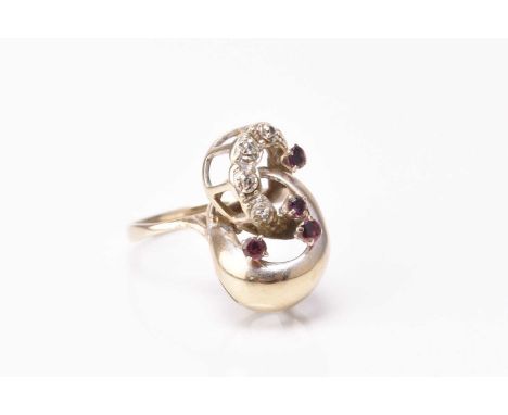 An untested ruby and diamond dress ring, of openwork scroll design, the shank stamped '18ct', ring size P, weight approx 4.7g