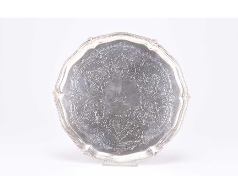 A Victorian silver salver, John Newton Mappin &amp; George Webb, London 1875, of circular form with engraved decoration to th